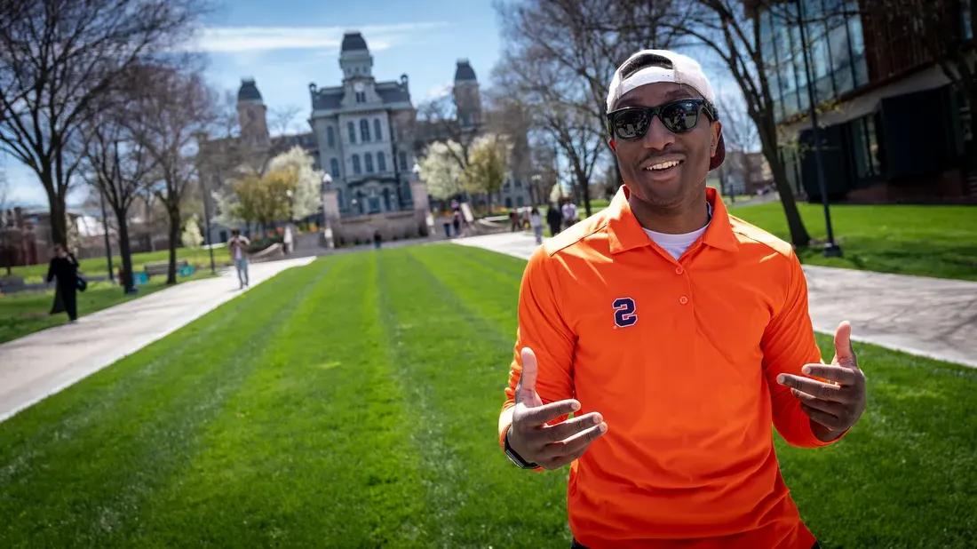 Student Michael Lupton standing outside the Hall of Languages on campus smiling.